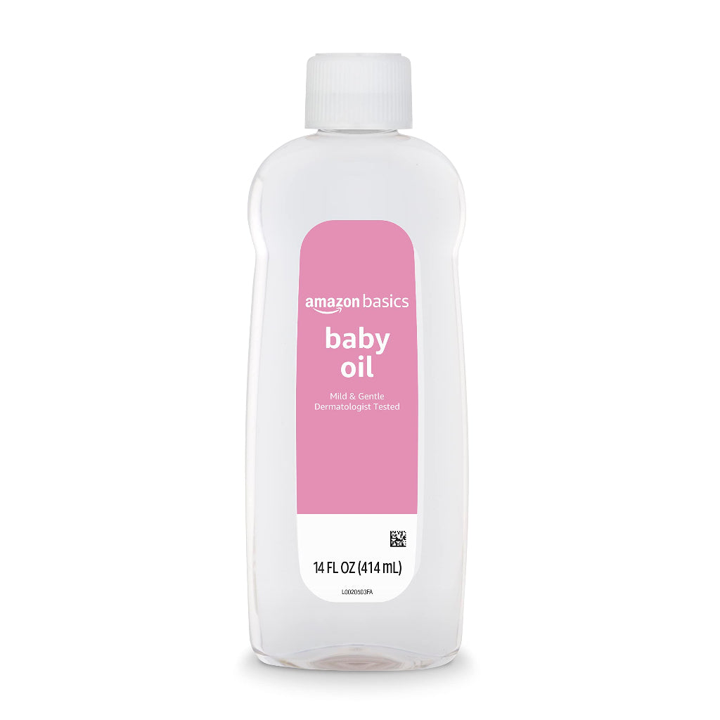 Amazon Basics baby oil bottle with pink label on a white background